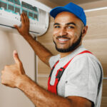 professional-repairman-installing-air-conditioner-HLXERZ5.jpg