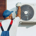 repairman-in-uniform-installing-the-outside-unit-o-LQWVHWK.jpg